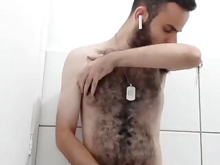 Young hairy guy jerking off in the shower